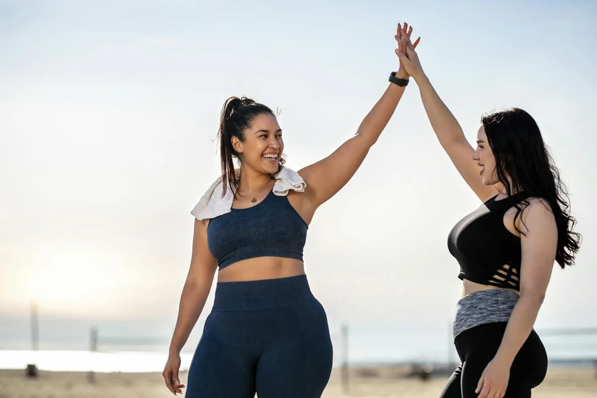 Two women celebrating together after outdoor exercise.