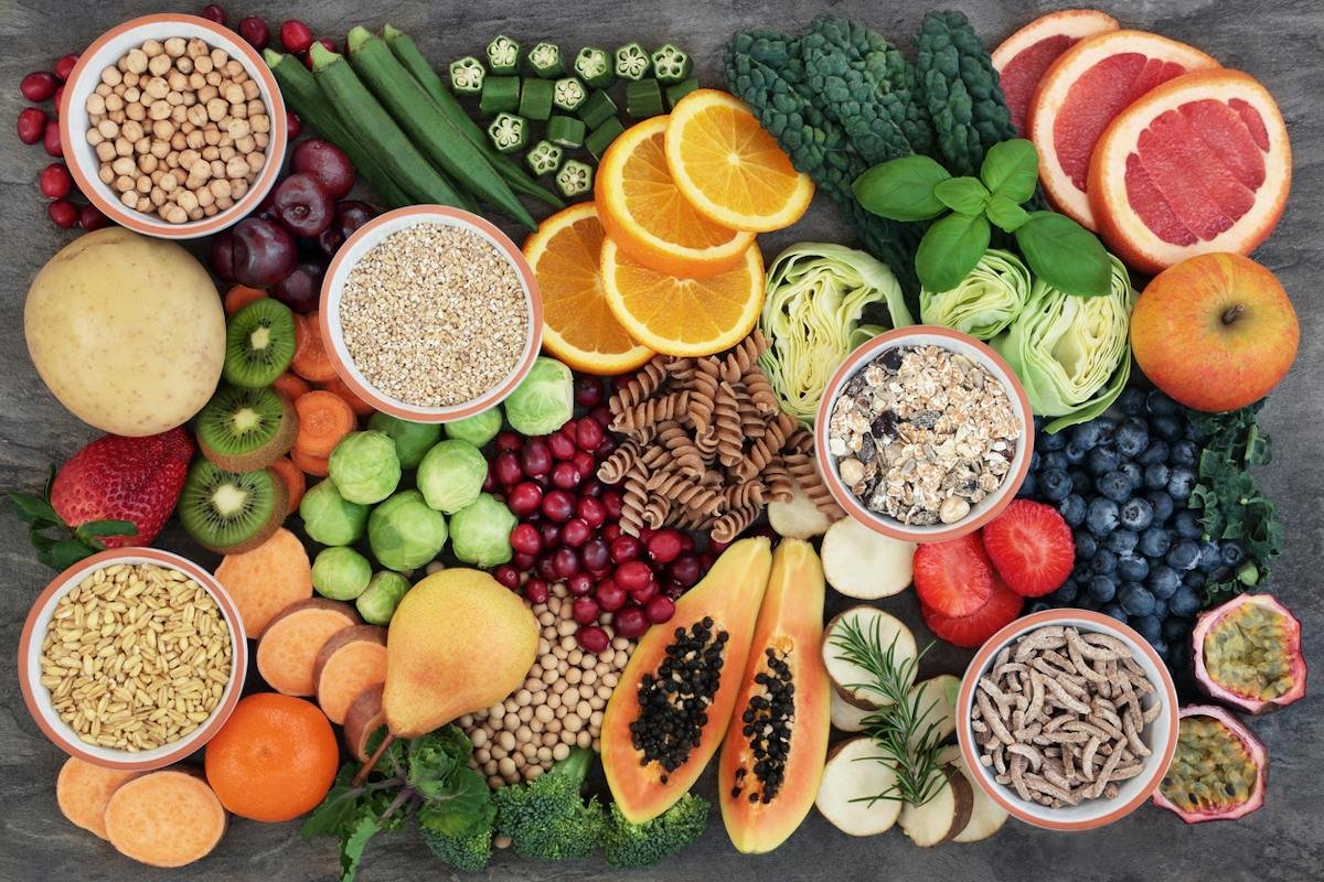 Assorted fruit, vegetables, grains, nuts, and legumes on a table