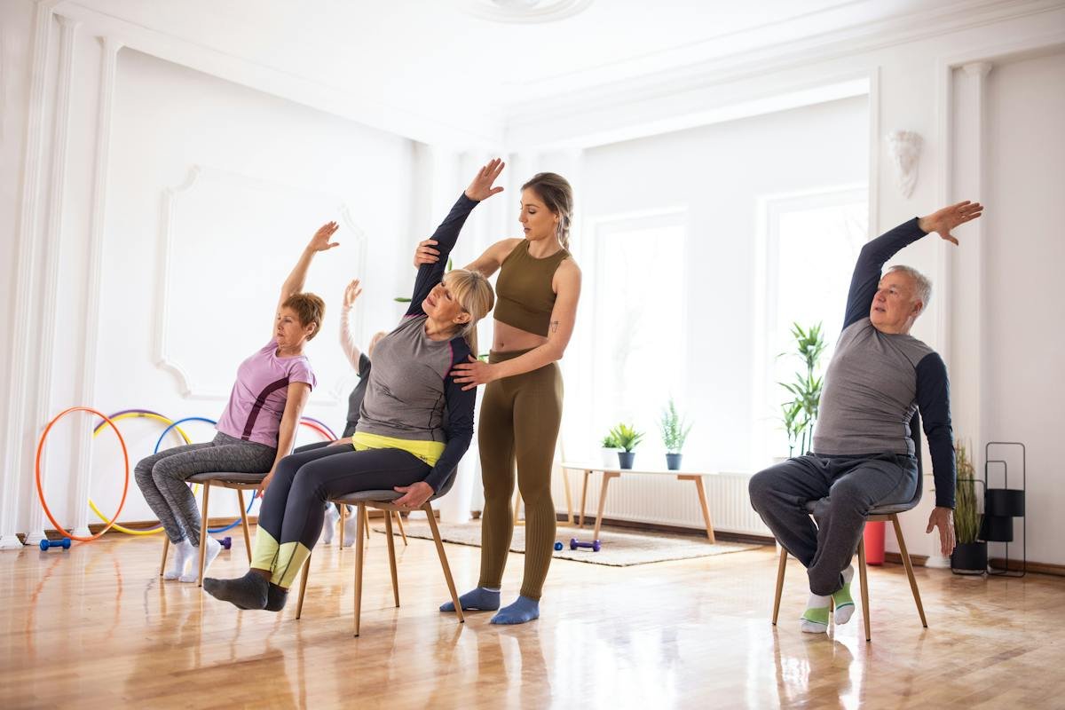 Group of older adults practicing supported chair exercises