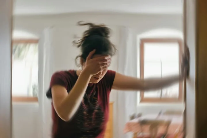 A person holding their head during a stressful moment.