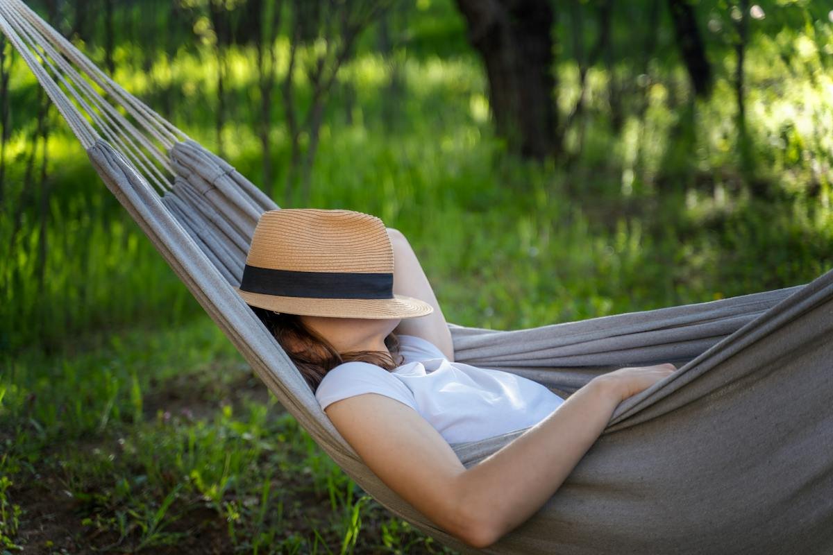 Person resting in a hammock outdoors